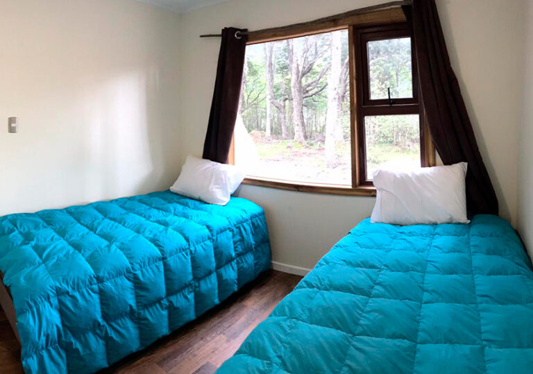 Room with two beds and a forest view at Chelenko